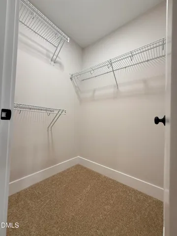 an empty room with windows and chandelier fan