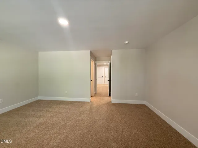 a white bath tub sitting next to a white wall