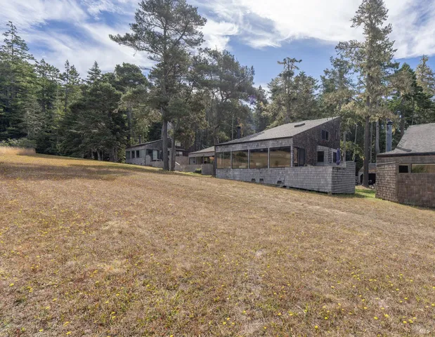 a backyard of a house with a yard and outdoor seating