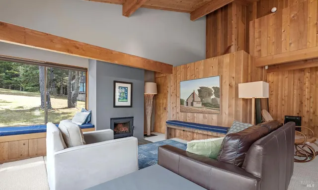 a living room with a couch and a dresser next to a window