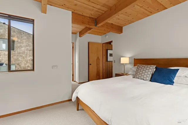 a bedroom with a bed and a night stand