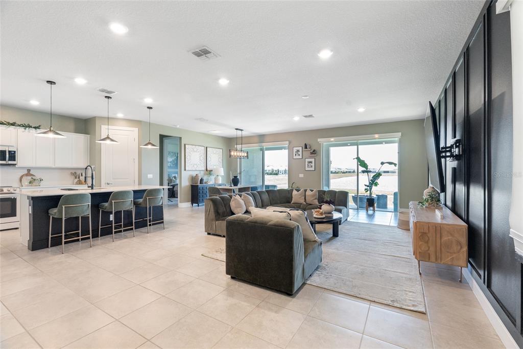 1634 Groveline Road St. Cloud, FL 34771 - Photo 7 of 43 a living room with furniture a large window and kitchen view
