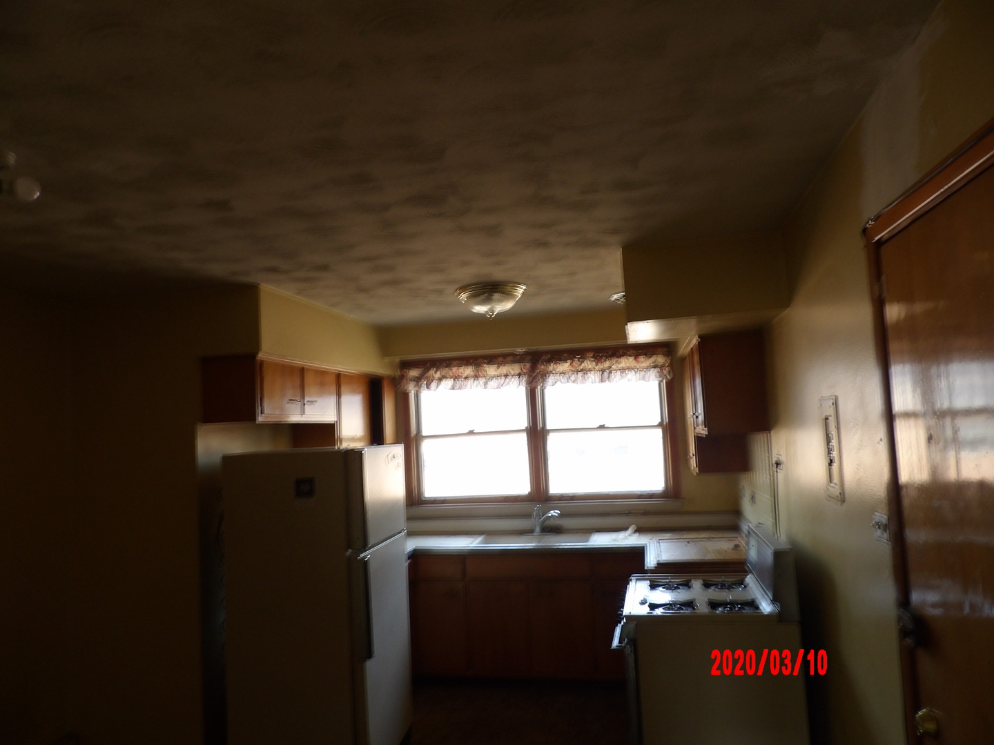 9211 South Cottage Grove Avenue, Unit 9C2 Chicago, IL 60619 - Photo 6 of 6 a kitchen with stainless steel appliances kitchen island granite countertop a refrigerator a stove a sink and dishwasher