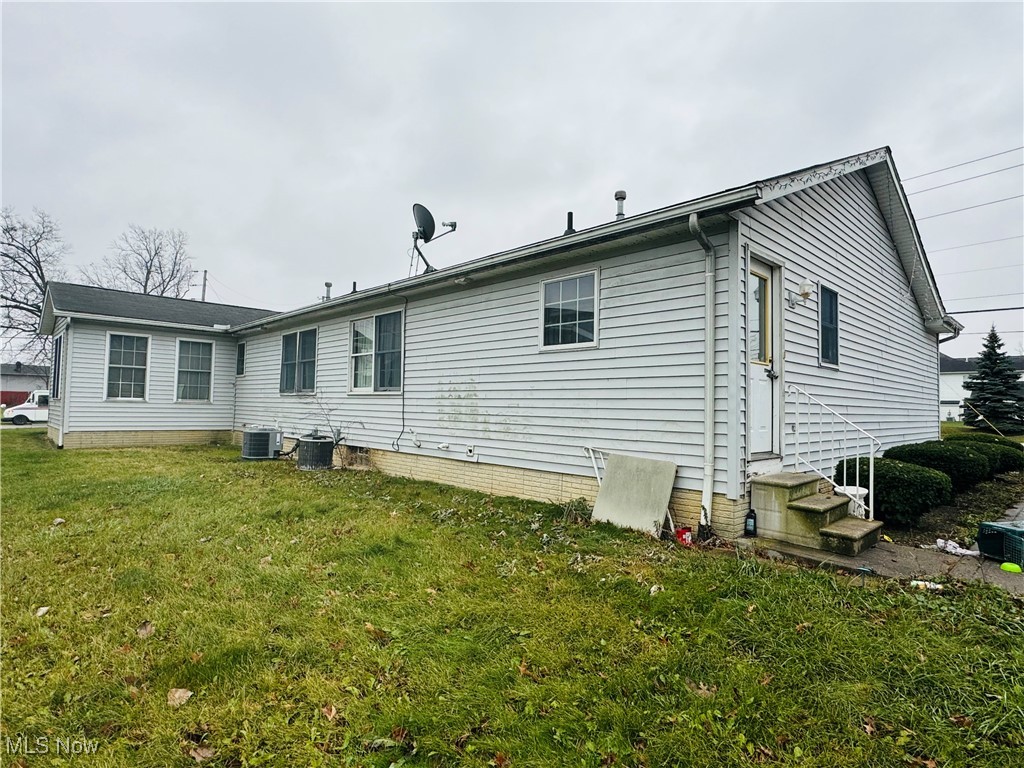 4400 Meister Road Lorain, OH 44053 - Photo 3 of 18 Back of property with central AC unit and a yard