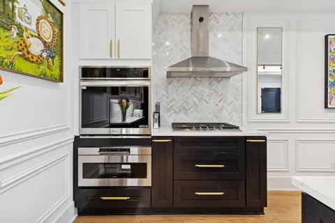 a kitchen with stainless steel appliances granite countertop a stove and a refrigerator
