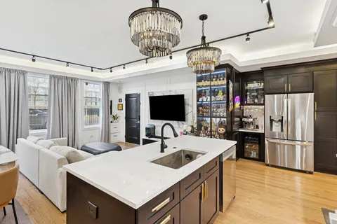 a kitchen with stainless steel appliances granite countertop a sink a stove and a refrigerator