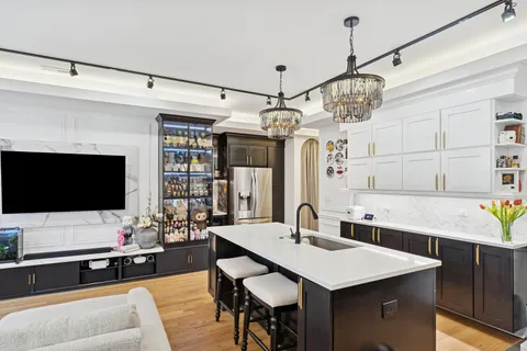 a view of a dining room with furniture a chandelier and wooden floor