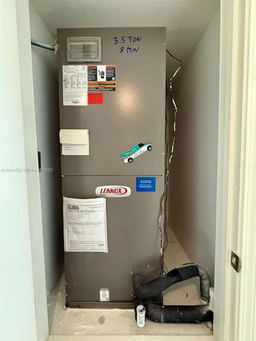 a room with water heater and refrigerator