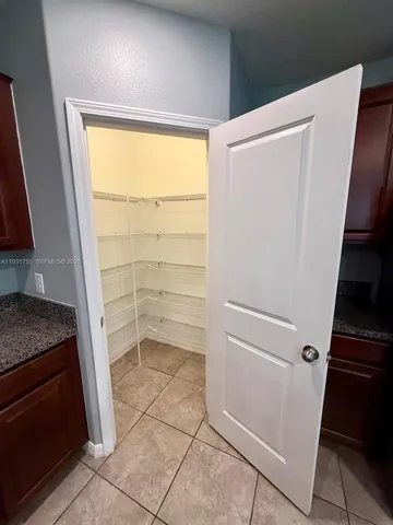 a view of storage and utility room with refrigerator