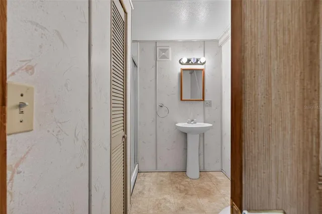 a bedroom with a large bed couch and a window