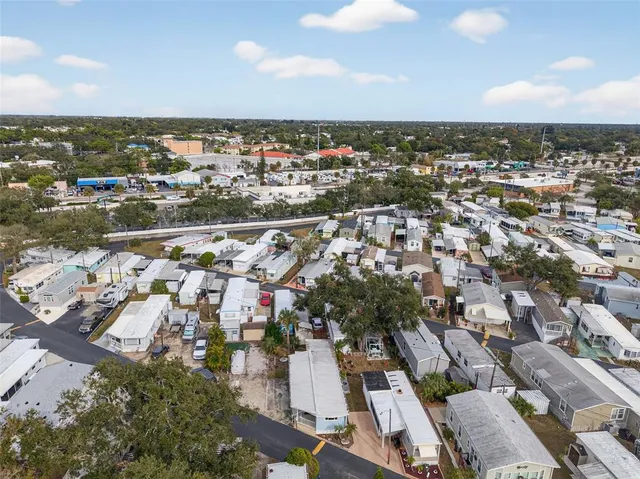 an aerial view of ocean and residential houses with outdoor space