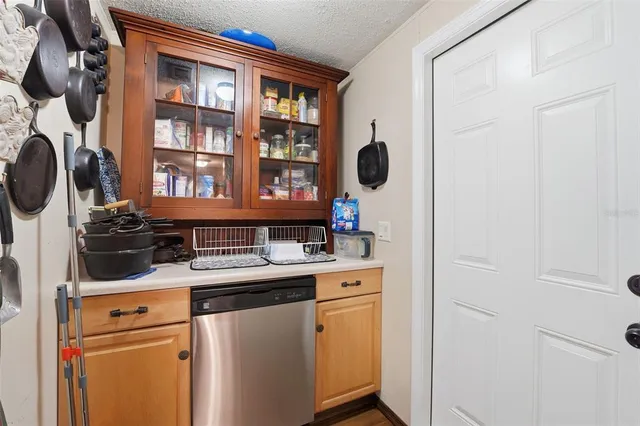 a kitchen with stainless steel appliances a refrigerator a stove a sink dishwasher with a dining table and chairs