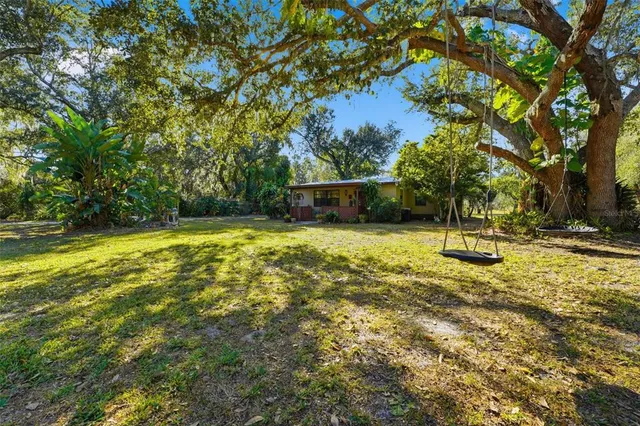 a view of a house with a yard and garage