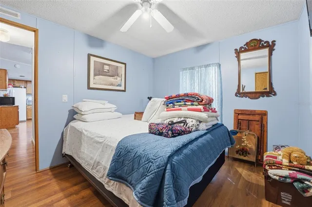 a bedroom with two beds and a flat screen tv