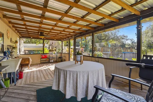 a living room with furniture a wooden floor and next to a window