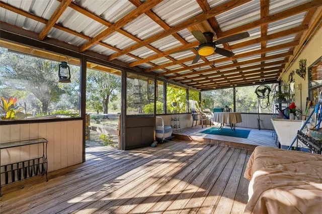 a view of a patio with table and chairs under an umbrella