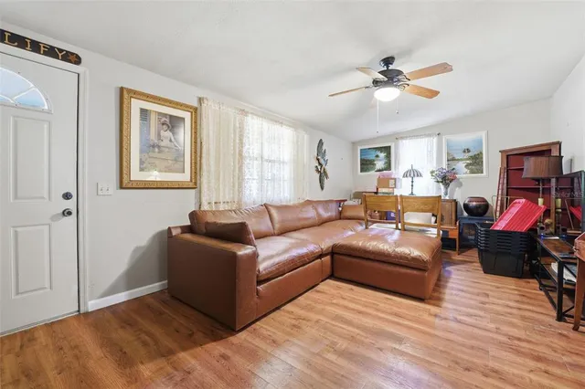 a living room with furniture and wooden floor