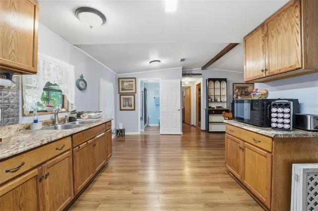 a kitchen with stainless steel appliances a refrigerator sink and cabinets