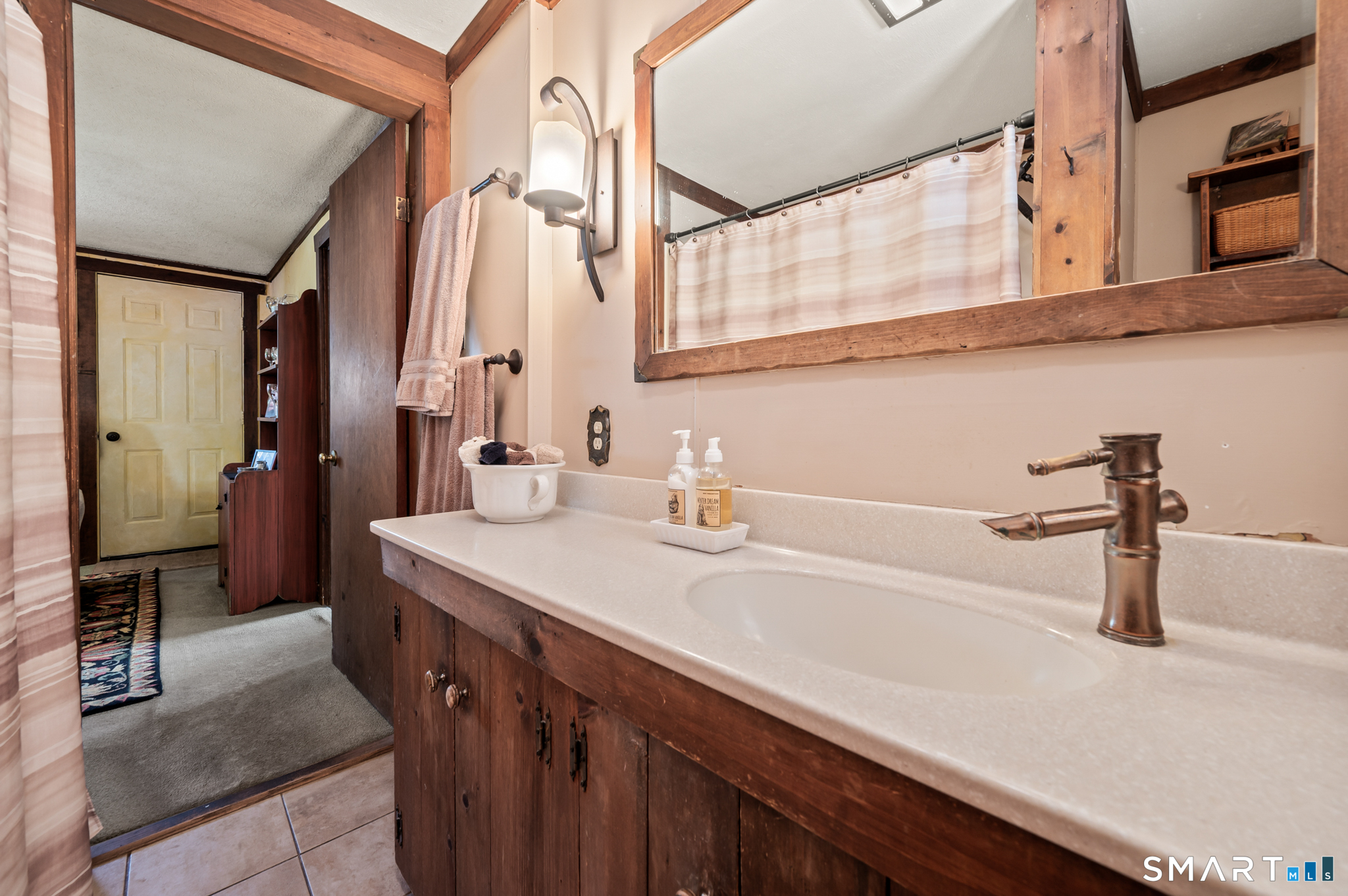 12 Booth Road Enfield, CT 06082 - Photo 22 of 30 a bathroom with a sink and a mirror