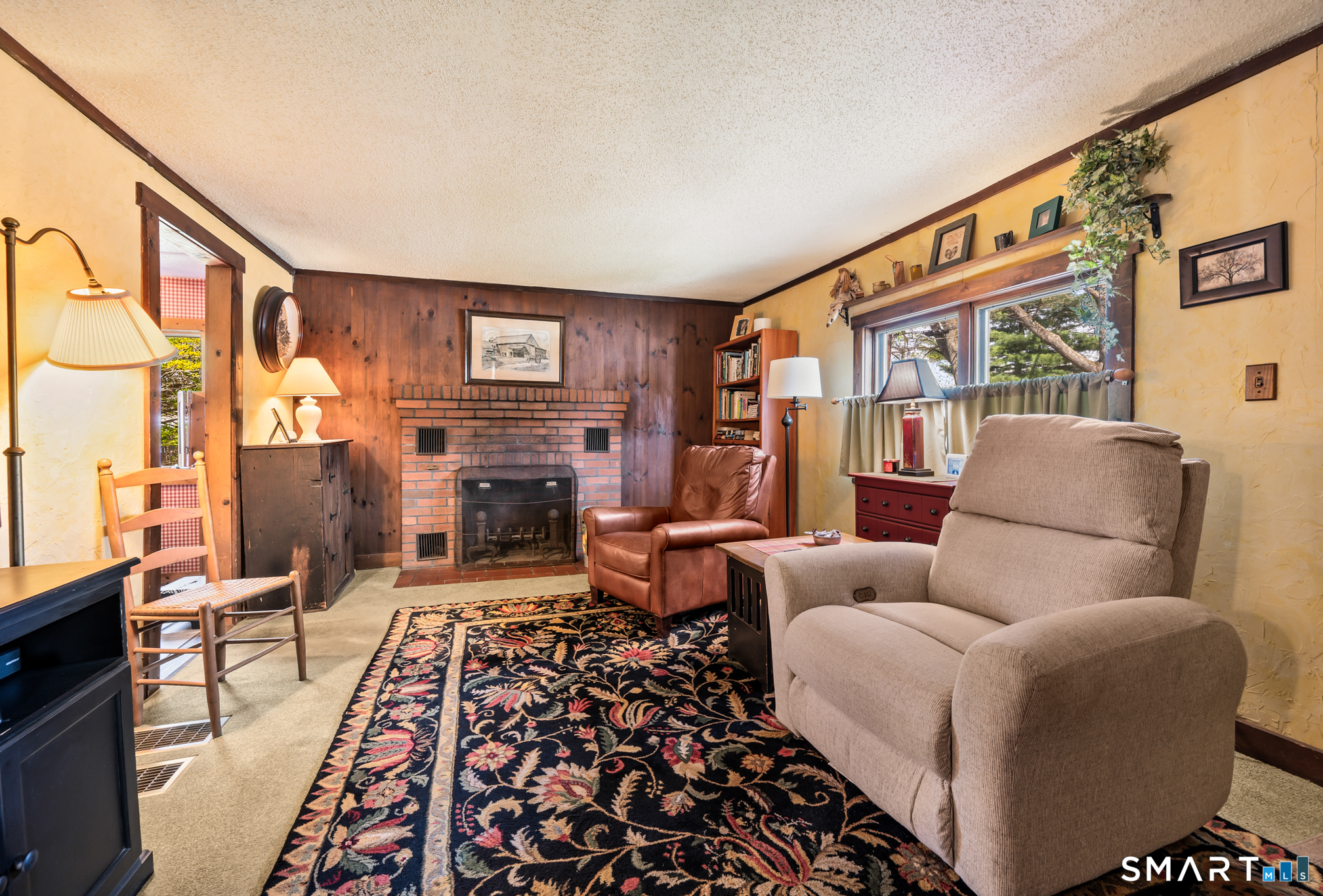 12 Booth Road Enfield, CT 06082 - Photo 24 of 30 a living room with furniture a flat screen tv and a fireplace