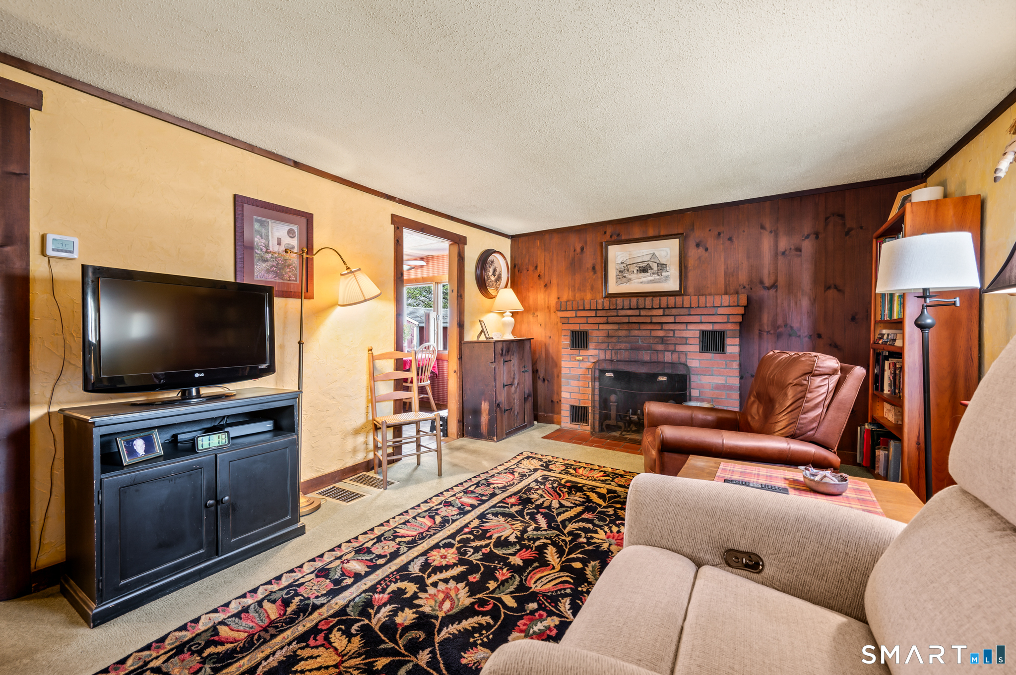 12 Booth Road Enfield, CT 06082 - Photo 25 of 30 a living room with furniture and a flat screen tv