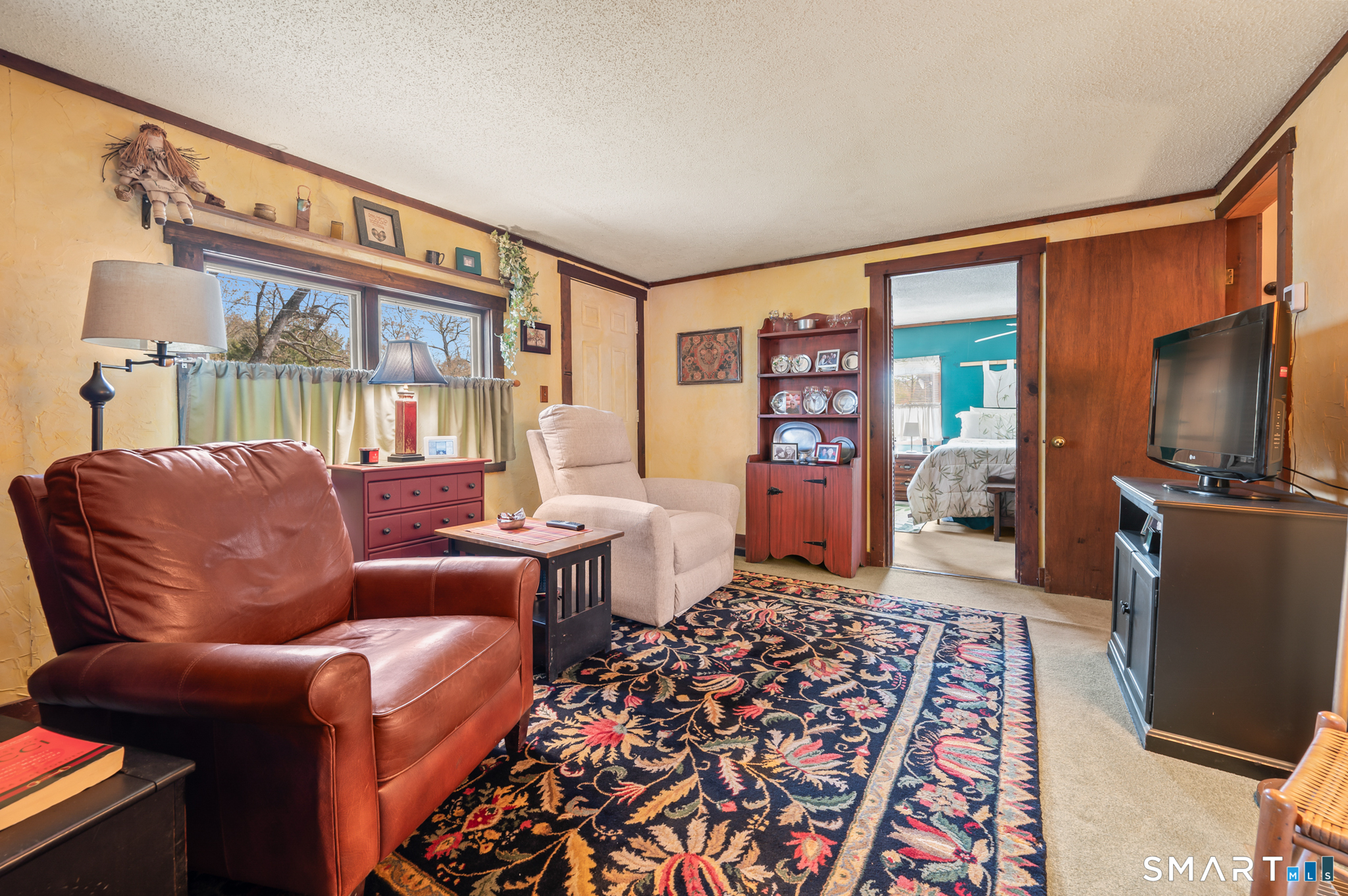 12 Booth Road Enfield, CT 06082 - Photo 27 of 30 a living room with furniture a flat screen tv and a rug