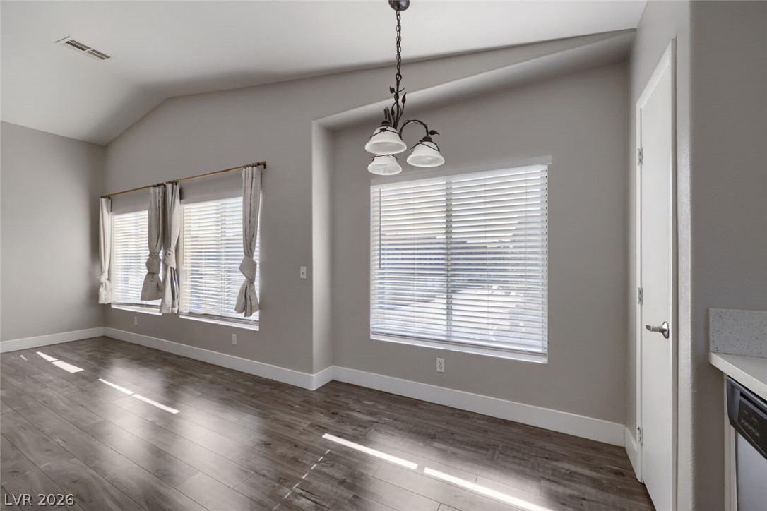 5985 High Steed Street, Unit 101 Henderson, NV 89011 - Photo 15 of 38 Hardwood floors and vaulted ceilings elevate this well-lit open-concept space.