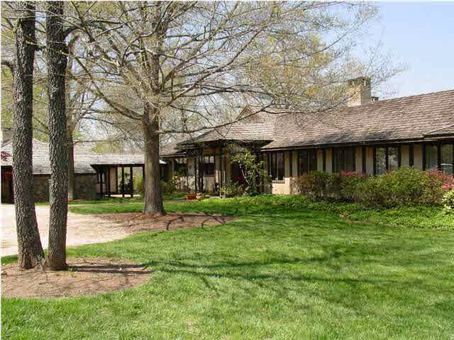 a view of a house with backyard porch and sitting area