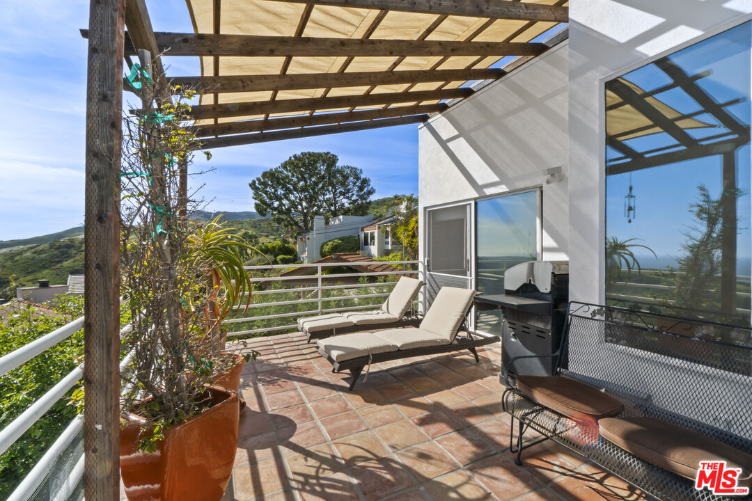 2977 Seabreeze Drive Malibu, CA 90265 - Photo 29 of 48 a view of a chairs and table in a patio