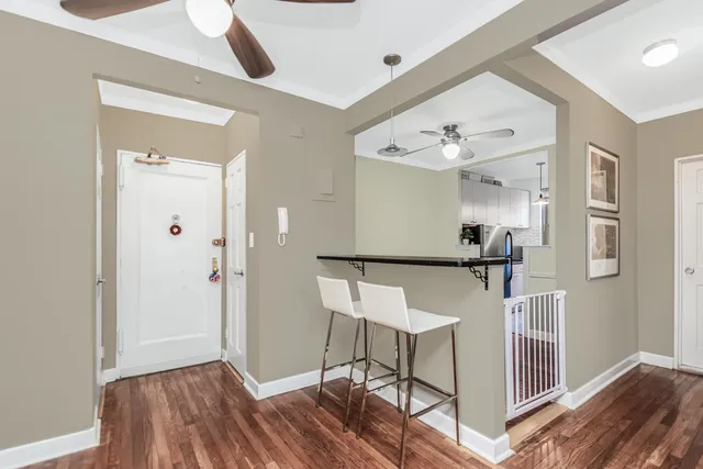 a view of a hallway with wooden floor and staircase