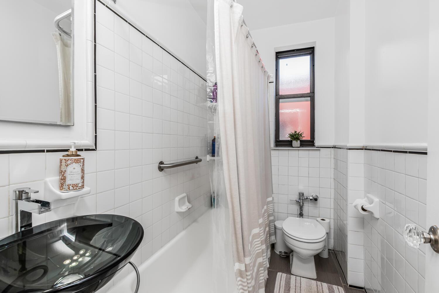 512 Kappock Street, Unit 3J Bronx, NY 10463 - Photo 10 of 20 a bathroom with a sink a toilet and shower