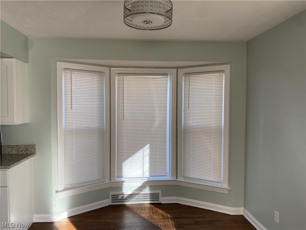 1147 Richmond Road Cleveland, OH 44124 - Photo 7 of 28 Unfurnished dining area with dark wood-type flooring