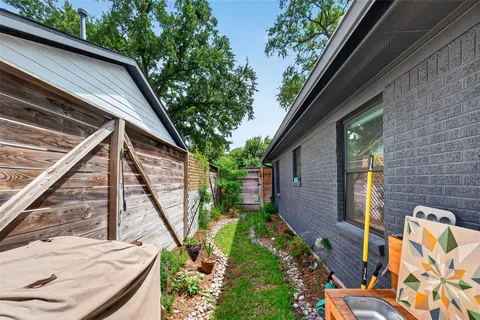 a view of a chair and table in the backyard of the house