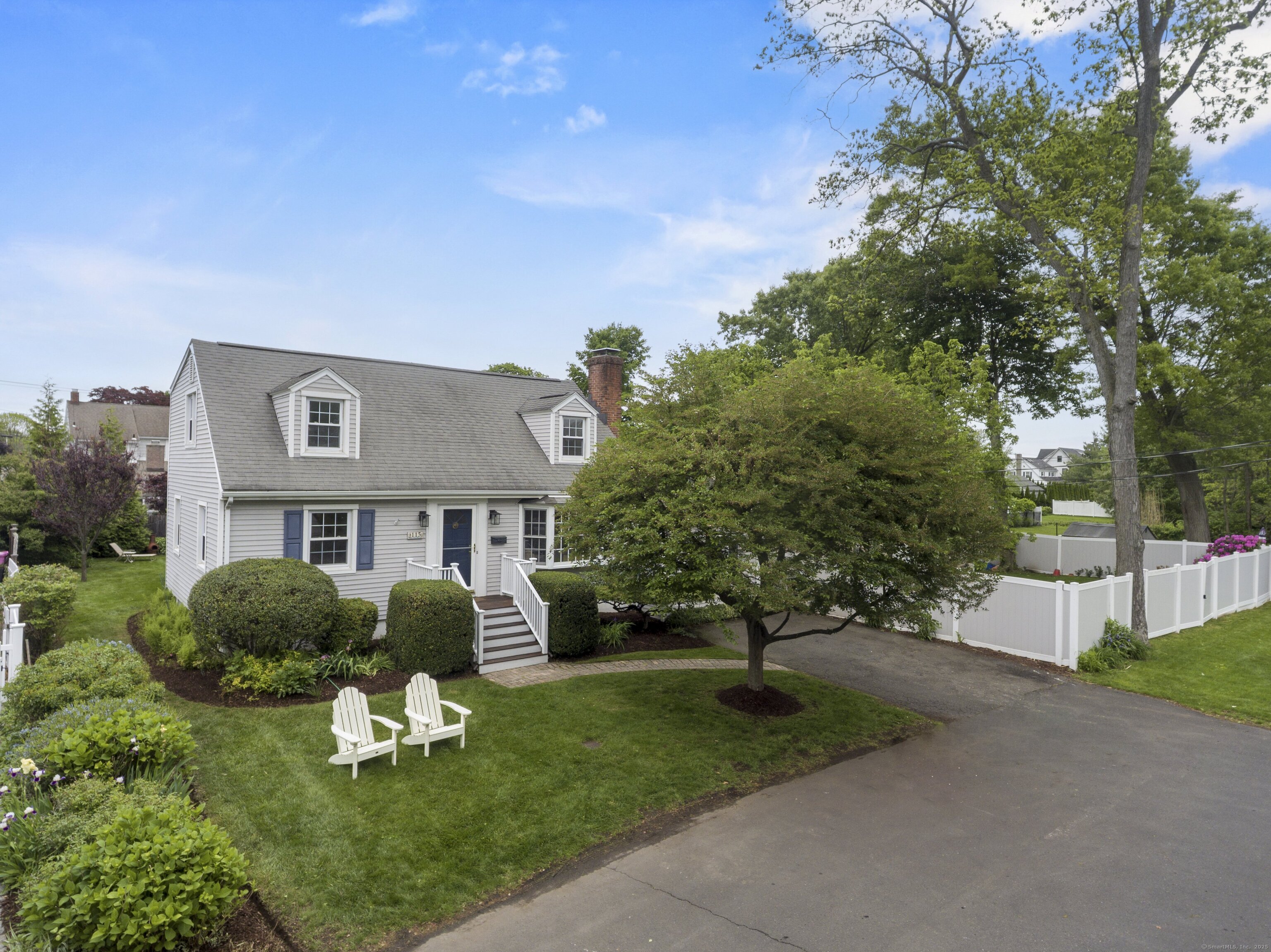 115 Dwight Street Fairfield, CT 06824 - Photo 1 of 1 a view of house with garden and tall trees