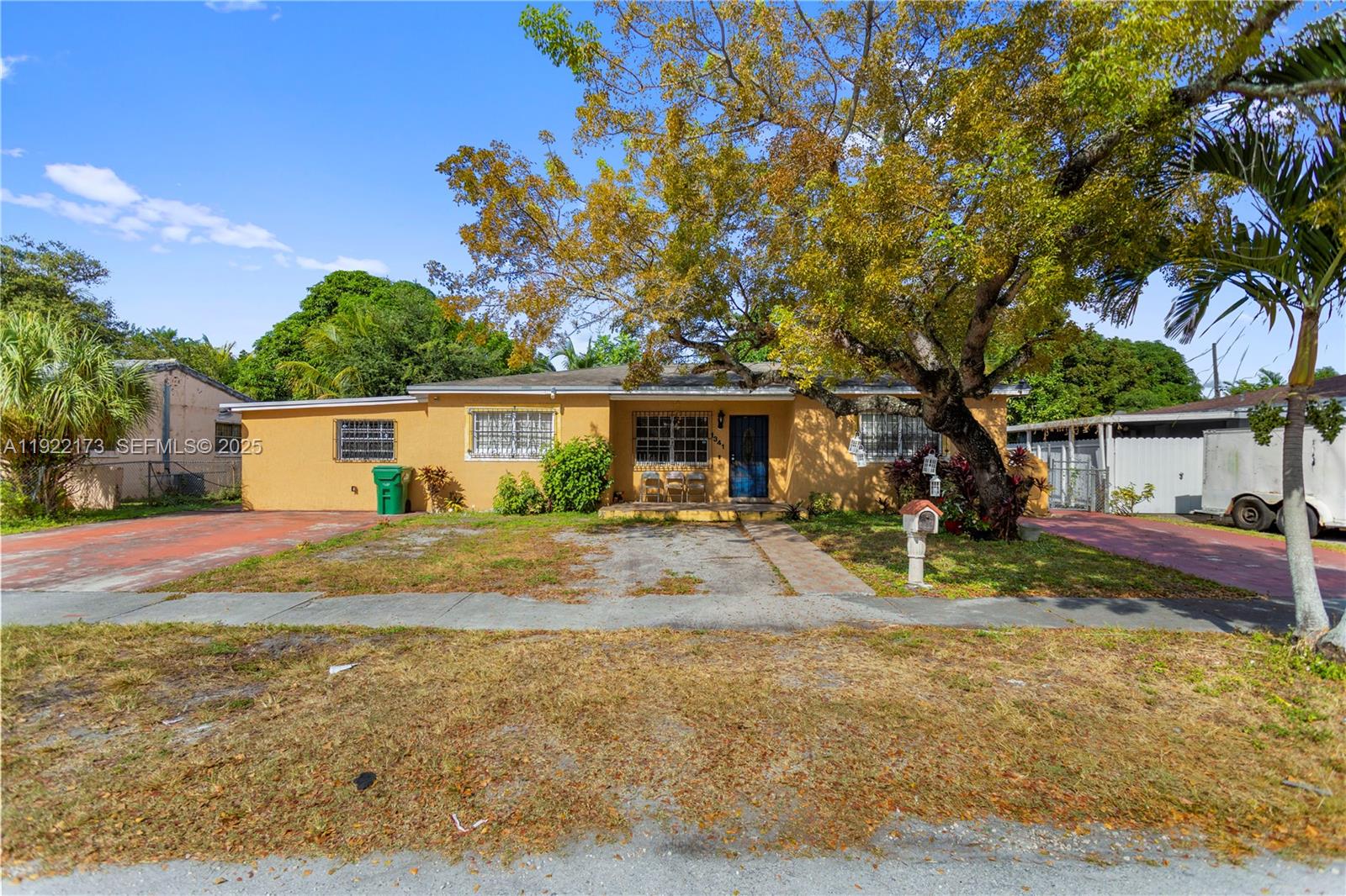 a view of a yard with a house and a tree