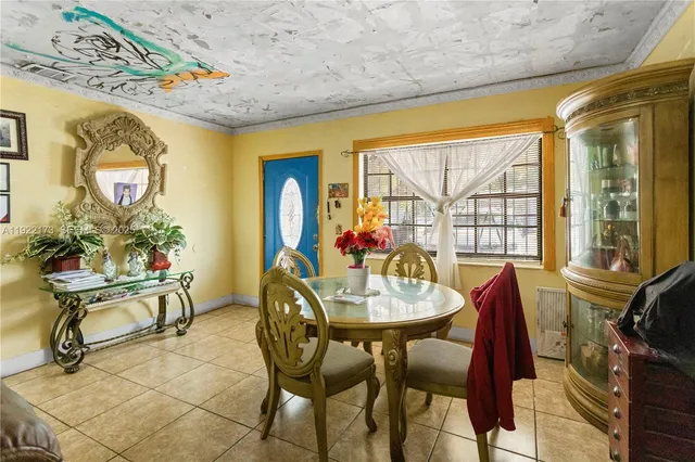 a view of a dining room with furniture and a window