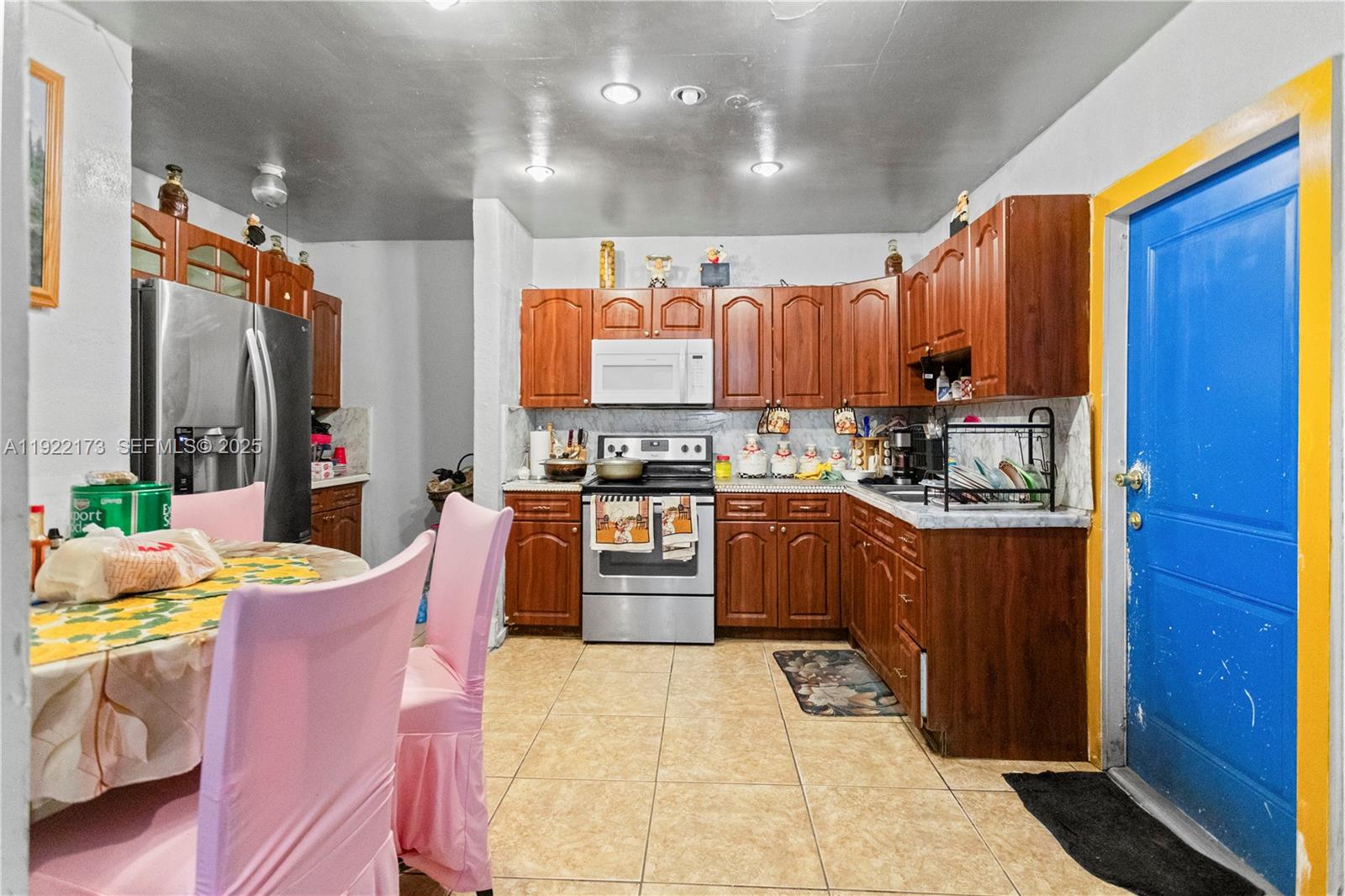 1341 Northwest 132nd Street Miami, FL 33167 - Photo 15 of 52 a kitchen with stainless steel appliances kitchen island granite countertop a refrigerator a stove top oven a sink and dishwasher