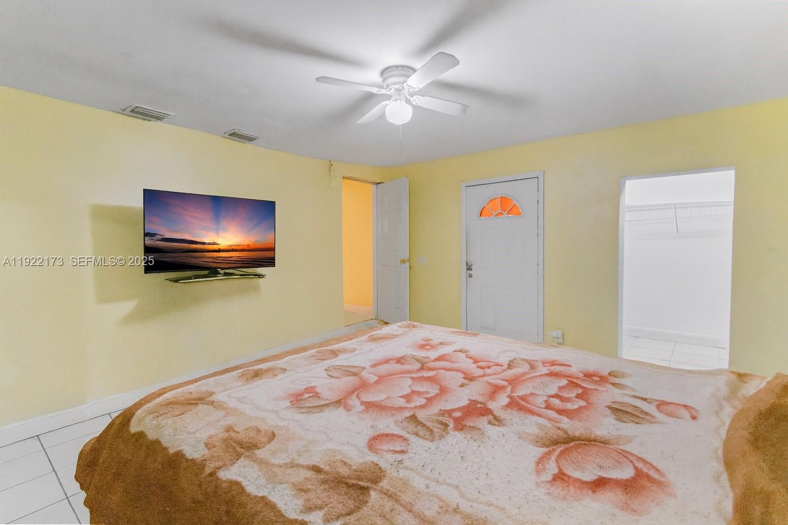 1341 Northwest 132nd Street Miami, FL 33167 - Photo 19 of 52 a bedroom with a bed and a chandelier
