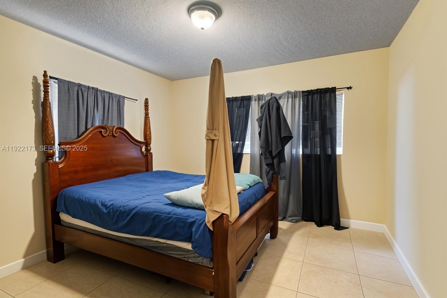 1341 Northwest 132nd Street Miami, FL 33167 - Photo 23 of 52 a bedroom with a bed and a walk in closet