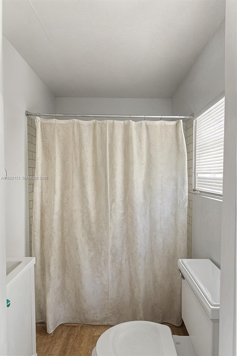 1341 Northwest 132nd Street Miami, FL 33167 - Photo 24 of 52 a white toilet sitting next to a small window