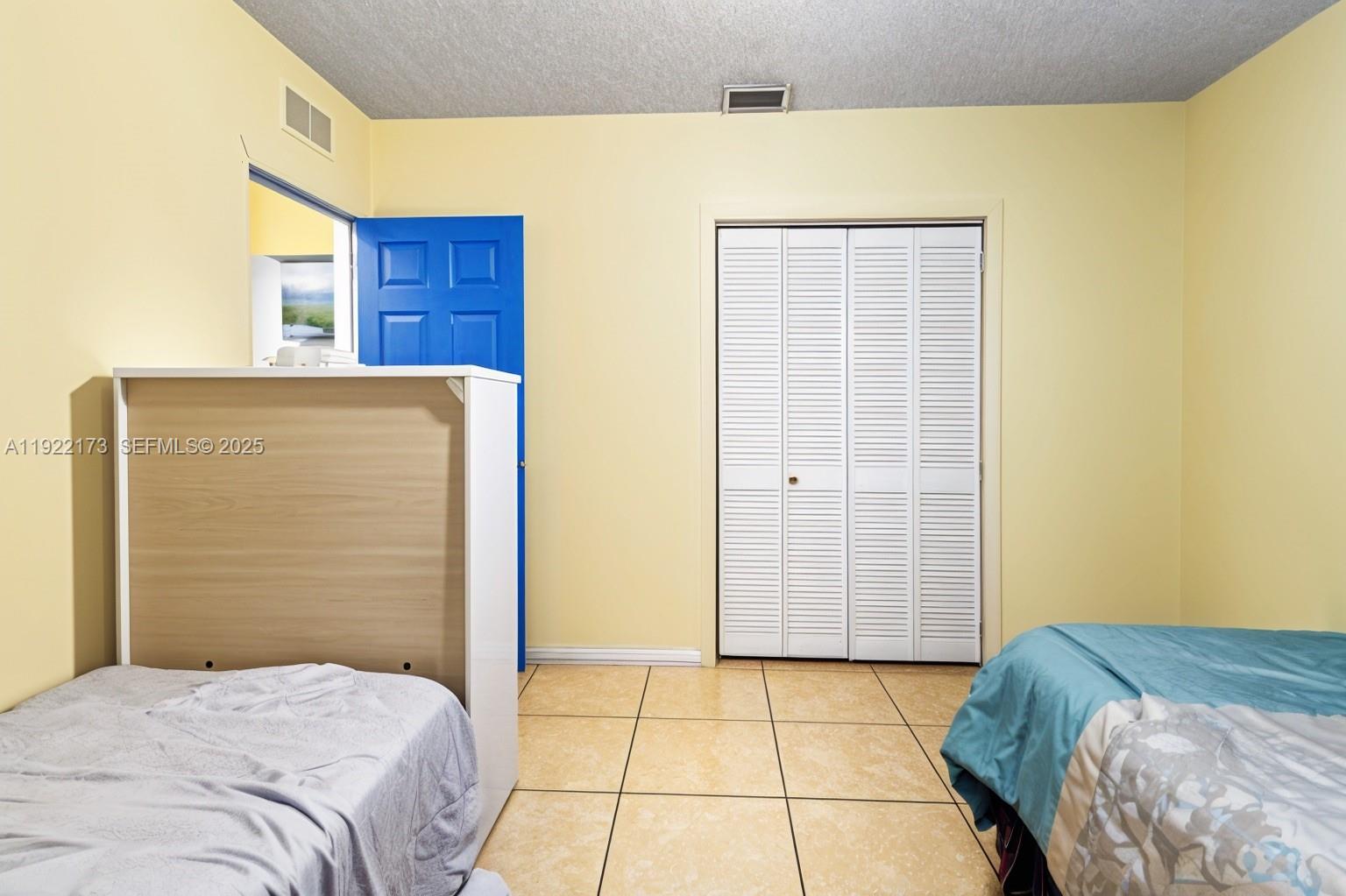 1341 Northwest 132nd Street Miami, FL 33167 - Photo 27 of 52 a bedroom with a bed