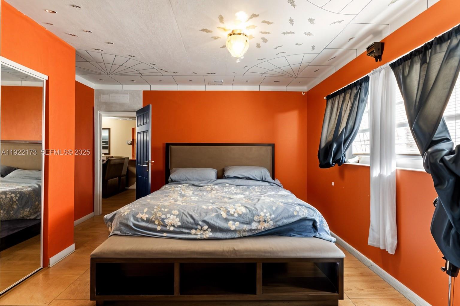 1341 Northwest 132nd Street Miami, FL 33167 - Photo 31 of 52 a bedroom with a bed and a chandelier