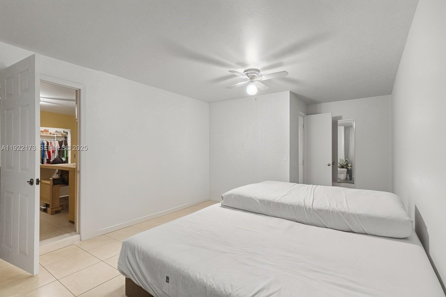 1341 Northwest 132nd Street Miami, FL 33167 - Photo 34 of 52 a bedroom with a large bed and a chandelier
