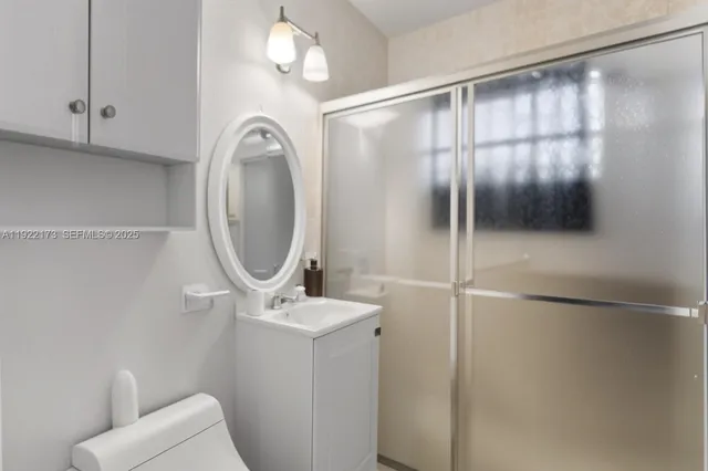 a bathroom with a mirror and a shower