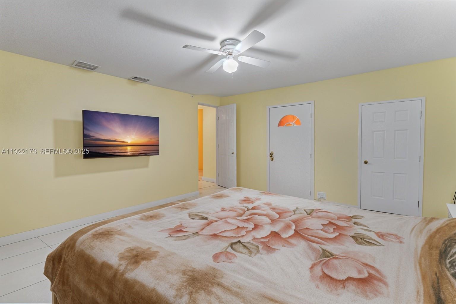 1341 Northwest 132nd Street Miami, FL 33167 - Photo 36 of 52 a bedroom with bed and a chandelier