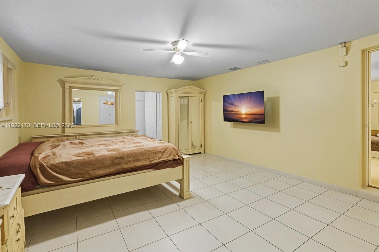 1341 Northwest 132nd Street Miami, FL 33167 - Photo 38 of 52 a bedroom with a bed and a chandelier