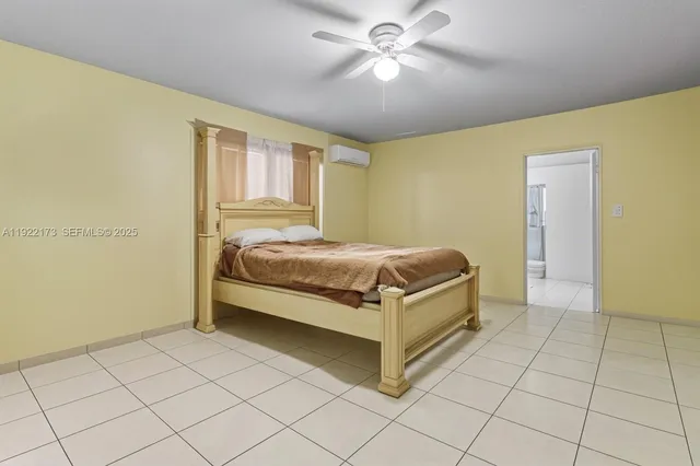 a bedroom with a bed and a ceiling fan