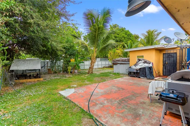 a view of a backyard with couches chair and a fire pit