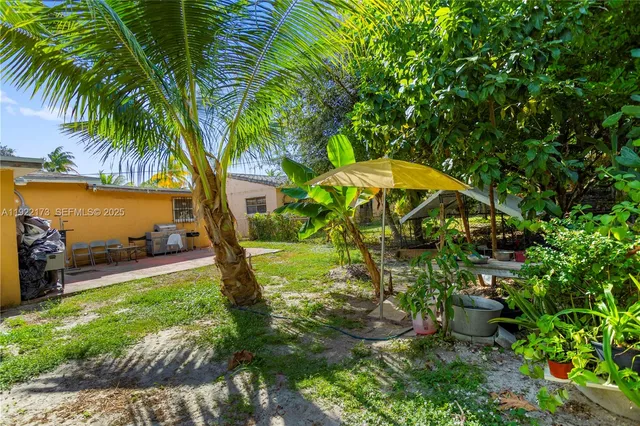 a view of a house with a yard and tree s