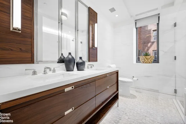 a bathroom with a double vanity sink and a mirror